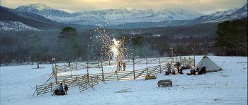 Movie still from “Rare Exports” (2010), directed by Jalmari Helander – A group of people standing in the snow near a fence; Extreme Wide shot, High angle