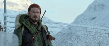 Movie still from “Rare Exports” (2010), directed by Jalmari Helander – A man with a beard holding a stick in his hand; Close Up shot, Low angle