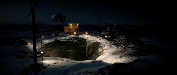 Movie still from “Rare Exports” (2010), directed by Jalmari Helander – A view of a construction site at night with snow; Extreme Wide shot, High angle