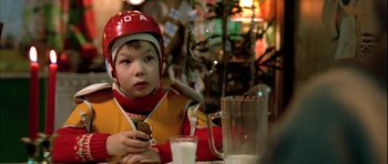 Movie still from “Rare Exports” (2010), directed by Jalmari Helander – A young boy sitting at a table with a glass of milk; Close Up shot, Over the shoulder angle