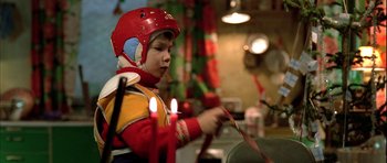 Movie still from “Rare Exports” (2010), directed by Jalmari Helander – A young boy wearing a helmet and holding a stick with candles; Medium shot, Low angle