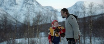 Movie still from “Rare Exports” (2010), directed by Jalmari Helander – A man and a boy are standing in the snow; Medium shot, Over the shoulder angle