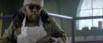 Movie still from “Rare Exports” (2010), directed by Jalmari Helander – A man with a beard wearing an apron and a hat; Medium shot, Low angle