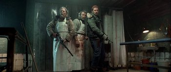 Movie still from “Rare Exports” (2010), directed by Jalmari Helander – A group of men standing next to each other holding guns; Medium shot, Low angle