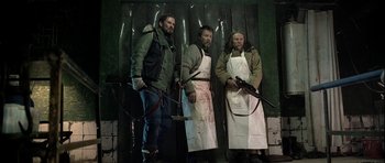 Movie still from “Rare Exports” (2010), directed by Jalmari Helander – A group of men standing next to each other holding weapons; Medium shot, Low angle