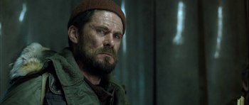 Movie still from “Rare Exports” (2010), directed by Jalmari Helander – A person wearing a hat and a jacket; Close Up shot, Over the shoulder angle