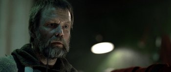 Movie still from “Rare Exports” (2010), directed by Jalmari Helander – A person with a beard looking at the camera; Close Up shot, Low angle