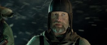 Movie still from “Rare Exports” (2010), directed by Jalmari Helander – A man with a beard wearing a viking helmet; Close Up shot, Low angle