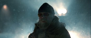 Movie still from “Rare Exports” (2010), directed by Jalmari Helander – A man with a beard wearing sunglasses in the snow; Close Up shot, Low angle