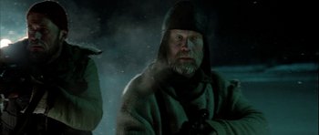 Movie still from “Rare Exports” (2010), directed by Jalmari Helander – A man with a beard wearing a hooded jacket; Close Up shot, Over the shoulder angle