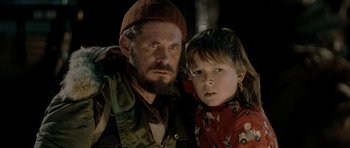 Movie still from “Rare Exports” (2010), directed by Jalmari Helander – A man and a boy are posing for a picture; Close Up shot, Over the shoulder angle