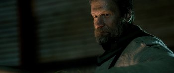 Movie still from “Rare Exports” (2010), directed by Jalmari Helander – A person with a beard looking at the camera; Close Up shot, Low angle