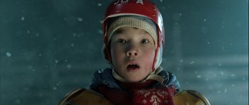 Movie still from “Rare Exports” (2010), directed by Jalmari Helander – A young boy wearing a helmet and a scarf; Close Up shot, Low angle
