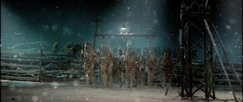 Movie still from “Rare Exports” (2010), directed by Jalmari Helander – A group of men are running in the snow; Wide shot, Low angle