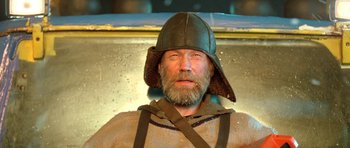 Movie still from “Rare Exports” (2010), directed by Jalmari Helander – A man with a beard wearing a viking helmet; Close Up shot, Low angle