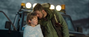 Movie still from “Rare Exports” (2010), directed by Jalmari Helander – A man and a boy are standing next to each other; Close Up shot, Over the shoulder angle