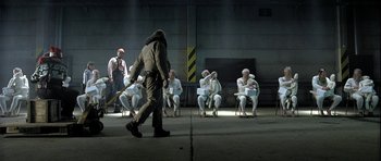 Movie still from “Rare Exports” (2010), directed by Jalmari Helander – A group of people sitting on chairs in a room; Wide shot, High angle