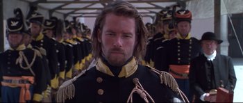 Movie still from “Ravenous” (1999), directed by Antonia Bird – A person wearing a uniform; Close Up shot, Low angle