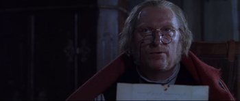 Movie still from “Ravenous” (1999), directed by Antonia Bird – A man with glasses holding a bloody knife; Close Up shot, Over the shoulder angle