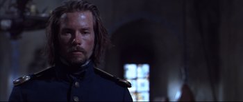 Movie still from “Ravenous” (1999), directed by Antonia Bird – A person wearing a uniform; Close Up shot, Low angle