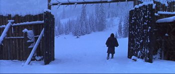Movie still from “Ravenous” (1999), directed by Antonia Bird – A person standing in the snow near a forest; Wide shot, High angle