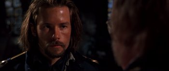 Movie still from “Ravenous” (1999), directed by Antonia Bird – A person with a beard; Close Up shot, Over the shoulder angle