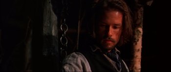 Movie still from “Ravenous” (1999), directed by Antonia Bird – A person with a beard; Close Up shot, Low angle