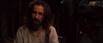 Movie still from “Ravenous” (1999), directed by Antonia Bird – A man with long hair and a long beard; Close Up shot, Low angle
