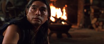 Movie still from “Ravenous” (1999), directed by Antonia Bird – A man with long black hair is looking at the camera; Close Up shot, Low angle