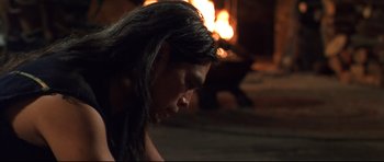 Movie still from “Ravenous” (1999), directed by Antonia Bird – A woman with long hair is looking down; Close Up shot, Over the shoulder angle