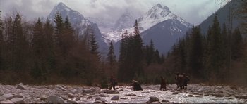 Movie still from “Ravenous” (1999), directed by Antonia Bird – A group of people standing on top of a rocky slope; Extreme Wide shot, High angle