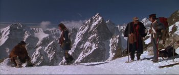 Movie still from “Ravenous” (1999), directed by Antonia Bird – A person on a snow board on a snowy mountain; Wide shot, Low angle