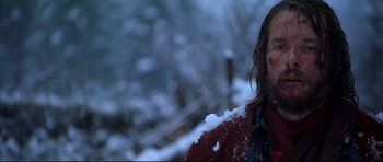 Movie still from “Ravenous” (1999), directed by Antonia Bird – A person standing in the middle of a snow covered field; Close Up shot, Low angle