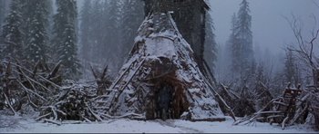 Movie still from “Ravenous” (1999), directed by Antonia Bird – A snowy scene with a teepee in the background; Wide shot, Low angle