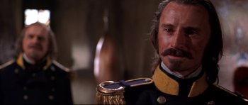 Movie still from “Ravenous” (1999), directed by Antonia Bird – A person wearing a uniform; Close Up shot, Low angle