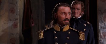 Movie still from “Ravenous” (1999), directed by Antonia Bird – A person wearing a uniform; Close Up shot, Over the shoulder angle