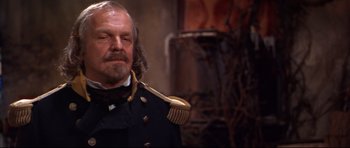 Movie still from “Ravenous” (1999), directed by Antonia Bird – An old man in a military uniform with a beard; Close Up shot, Low angle