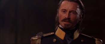 Movie still from “Ravenous” (1999), directed by Antonia Bird – A person wearing a military uniform; Close Up shot, High angle