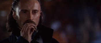 Movie still from “Ravenous” (1999), directed by Antonia Bird – A person holding a cigarette in his mouth; Close Up shot, Low angle