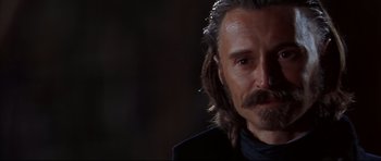 Movie still from “Ravenous” (1999), directed by Antonia Bird – A person with long hair; Close Up shot, Over the shoulder angle