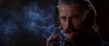 Movie still from “Ravenous” (1999), directed by Antonia Bird – A person smoking a cigarette; Close Up shot, Low angle