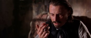 Movie still from “Ravenous” (1999), directed by Antonia Bird – A person holding a cell phone; Close Up shot, High angle