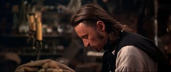 Movie still from “Ravenous” (1999), directed by Antonia Bird – A person with long brown hair; Close Up shot, Over the shoulder angle