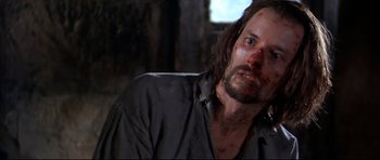 Movie still from “Ravenous” (1999), directed by Antonia Bird – A person wearing a shirt; Close Up shot, Over the shoulder angle