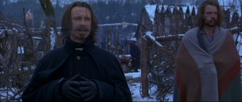 Movie still from “Ravenous” (1999), directed by Antonia Bird – A man standing in the middle of a snow covered field; Medium shot, Low angle