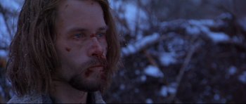 Movie still from “Ravenous” (1999), directed by Antonia Bird – A person with blood on his face; Close Up shot, Over the shoulder angle