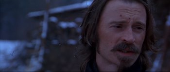 Movie still from “Ravenous” (1999), directed by Antonia Bird – A person with long brown hair; Close Up shot, Over the shoulder angle