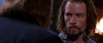 Movie still from “Ravenous” (1999), directed by Antonia Bird – A man with long hair is looking at another man with long hair; Close Up shot, Over the shoulder angle