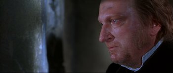 Movie still from “Ravenous” (1999), directed by Antonia Bird – A person looking at the camera; Close Up shot, Low angle