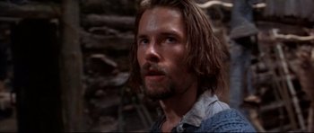 Movie still from “Ravenous” (1999), directed by Antonia Bird – A person with long brown hair; Close Up shot, Low angle